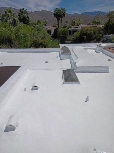 Finished cool roof on a Palm Springs flat-roof home with mountain backdrop