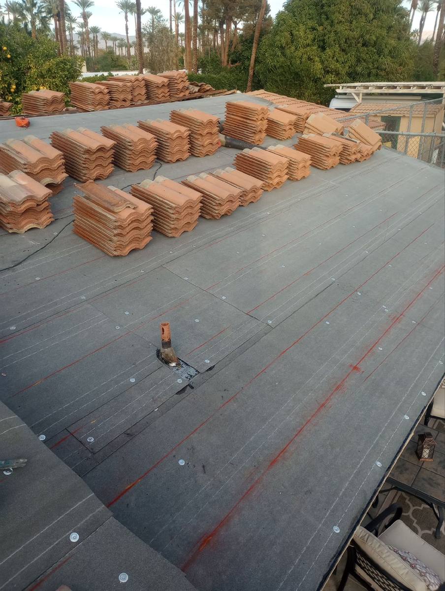 Tile re-roof underway with new tile stacks staged on the deck